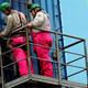 Illustration for article titled Germans Don Cute Pink Overalls To Festoon Ford Plant With Fiesta Banners